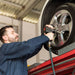 Serenity Choice Reusable Hearing Protection  for use with impact sounds such as in a tire shop.  A bearded gentleman dressed in blue coveralls is installing tires holding an impact wrench. 